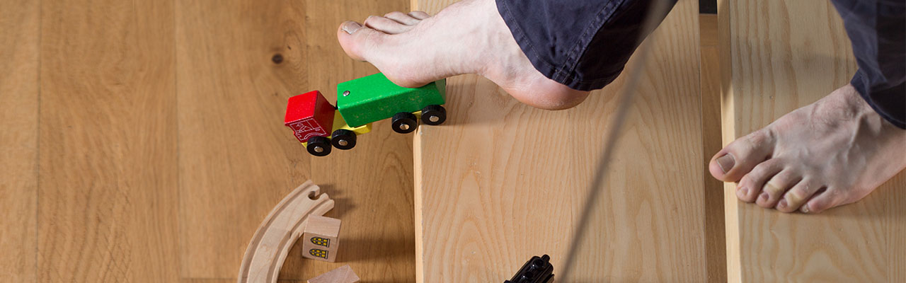 A man getting ready to slip and fall on a toy train has accident insurance.